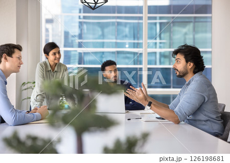 Middle-aged team leader makes speech at briefing in conference room Middle-aged team leader makes speech at briefing in conference room 126198681