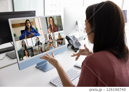 Busy young woman in headphones with mic speaking on webinar 126198740