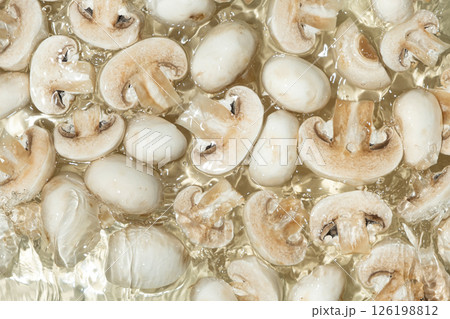 Raw White Mushrooms Champignons Close-Up Splash in a Water Top View 126198812