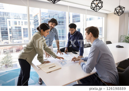 Indian professional woman developing marketing strategy with teammates Indian professional woman developing marketing strategy with teammates 126198889