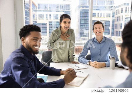 Four diverse colleagues laughing during informal meeting Four diverse colleagues laughing during informal meeting 126198903