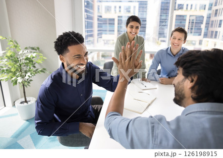 Two business professionals enthusiastically exchange high-five gesture 126198915