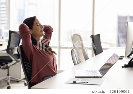 Carefree peaceful young woman relax at workplace after finishing work 126199061