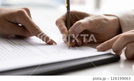 Closeup lawyer hand show client place to sign on contract Closeup lawyer hand show client place to sign on contract 126199063