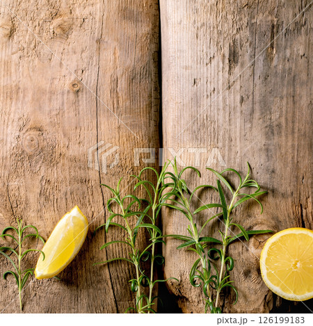 Fresh organic sliced lemon and rosemary branches Fresh organic sliced lemon and rosemary branches 126199183