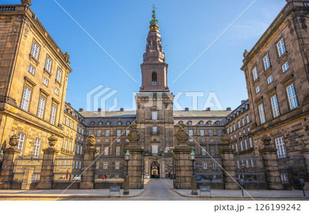 Christiansborg Palace stands majestically on Slotsholmen islet in central Copenhagen. Its stunning architecture and historical significance attract many visitors throughout the year. Christiansborg Palace stands majestically on Slotsholmen islet in central Copenhagen. Its stunning architecture and historical significance attract many visitors throughout the year. 126199242