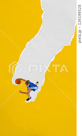 Female basketball player in blue uniform moves dynamically on ripped paper path over yellow background. Collage with paper texture. 126199328