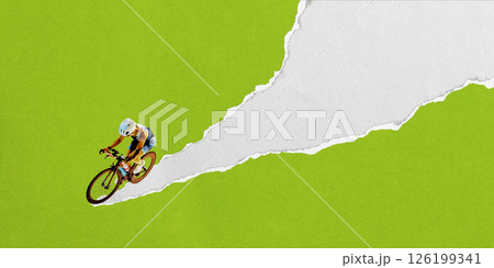Female triathlete on road bike races over ripped white trail on green background. Textured collage. 126199341