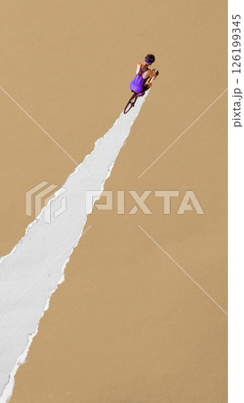 Female cyclist rides upward through torn white path on brown background. Contemporary paper cut style. Concept of sport, game, competition, movement, fitness Female cyclist rides upward through torn white path on brown background. Contemporary paper cut style. Concept of sport, game, competition, movement, fitness 126199345