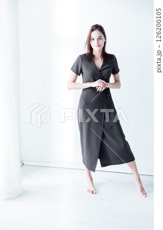 Portrait of Beautiful Brunette Woman in Green Grey Dress on White Background 126200105