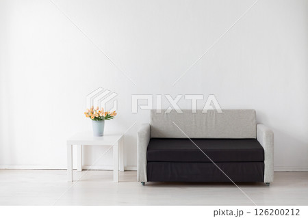 office sofa with flowers and gifts in the interior of a white room office sofa with flowers and gifts in the interior of a white room 126200212