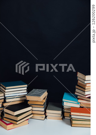Stacks of educational books for learning on a black background Stacks of educational books for learning on a black background 126200299