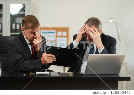 Failed teamwork concept, business team sitting sad and solving problems in the office. 126200473