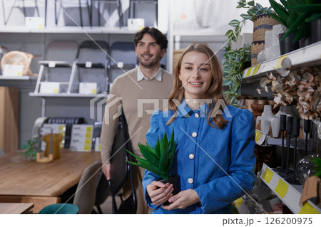 Couple browses a modern store for unique home decor to enhance her living space 126200975