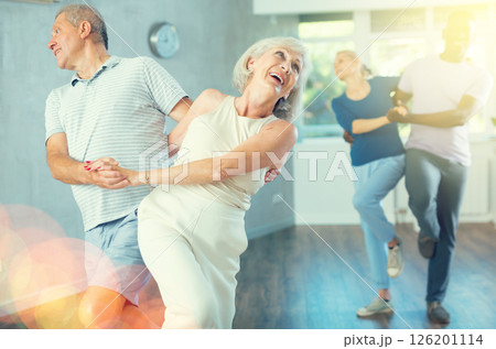 Group of multiethnic mature people dancing social dance 126201114