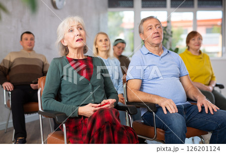 Adult students listening in classroom university 126201124