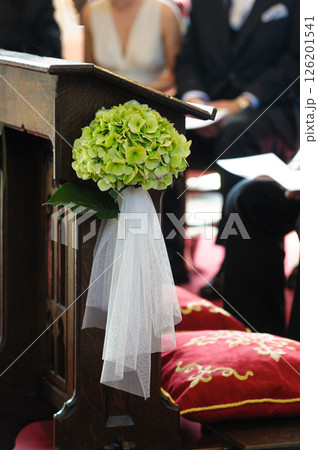 Flower Arrangement on Wooden Pulpit at a Wedding Ceremony Scene Flower Arrangement on Wooden Pulpit at a Wedding Ceremony Scene 126201541
