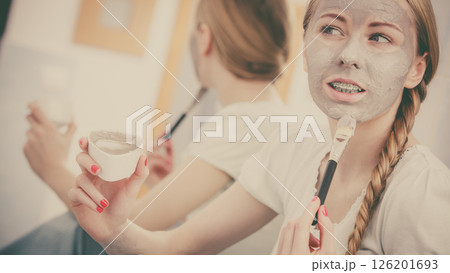 Woman with grey clay mud mask on her face 126201693