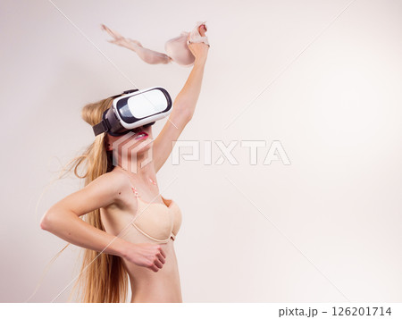 Girl in virtual reality goggles holds bra Girl in virtual reality goggles holds bra 126201714