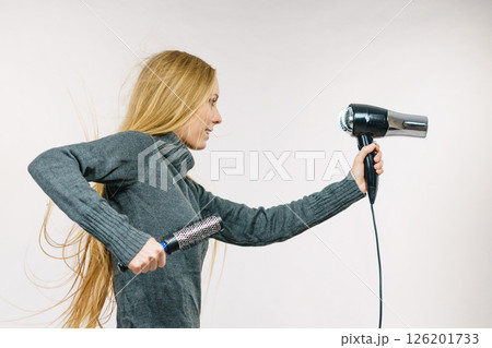 Girl holds hair accessories, styling hair 126201733