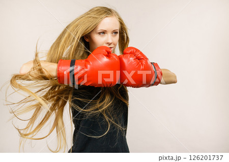 Woman in gloves playing sports boxing Woman in gloves playing sports boxing 126201737