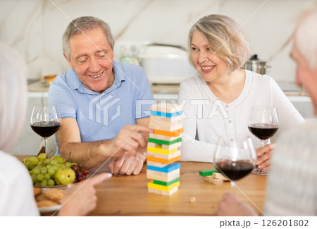Couples of elderly women and men playing bricks Couples of elderly women and men playing bricks 126201802