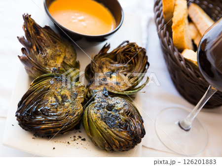 Grilled artichokes with romesco 126201883