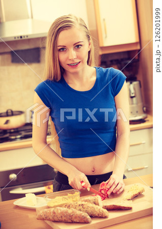 Woman preparing healthy breakfast making sandwich 126201999