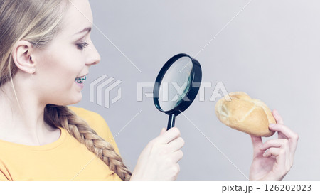 Bun bread roll and magnifying glass 126202023