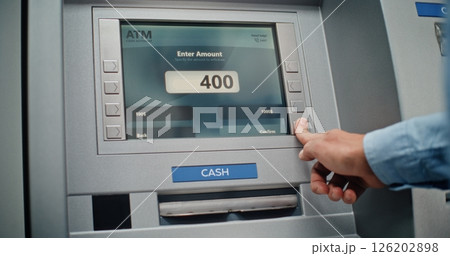Unrecognizable Man Entering PIN Code on Keypad, Taking US Dollars from ATM Machine Unrecognizable Man Entering PIN Code on Keypad, Taking US Dollars from ATM Machine 126202898