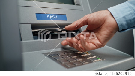 ATM Machine User Pressing Buttons on Display Screen, Taking Money from Cash Dispenser ATM Machine User Pressing Buttons on Display Screen, Taking Money from Cash Dispenser 126202910