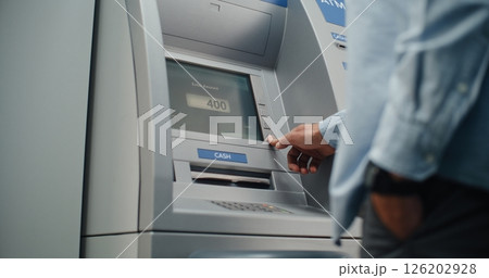 Close Up of Person Entering PIN Code. ATM Dispensing Money, User Taking Cash Dollars 126202928