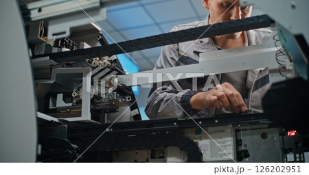 Technician Repairing Internal Components of Automated Teller Machine Technician Repairing Internal Components of Automated Teller Machine 126202951