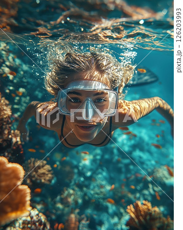 Graceful dive into turquoise waters reveals vibrant coral reefs and colorful marine life with a skilled diver enjoying underwater exploration Graceful dive into turquoise waters reveals vibrant coral reefs and colorful marine life with a skilled diver enjoying underwater exploration 126203993