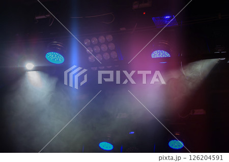 Stage lights with white and blue beams of light. 126204591
