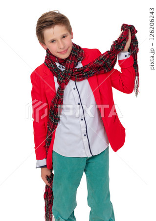 Portrait of smiling boy in red jacket and checkered scarf. Fashionable teenager in elegant clothes. Portrait of smiling boy in red jacket and checkered scarf. Fashionable teenager in elegant clothes. 126206243