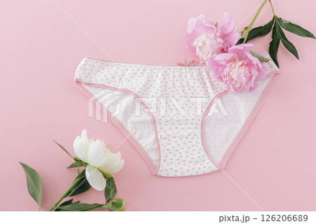White cotton women's panties on the pink background. White cotton women's panties on the pink background. 126206689