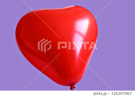 Red heart-shaped balloon on a turquoise background Red heart-shaped balloon on a turquoise background 126207867