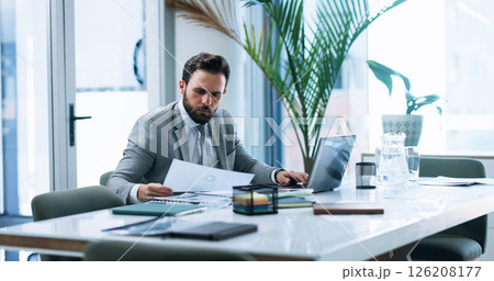 Documents, accountant or businessman with laptop for budget savings, risk assessment or research. Financial management, review or investment banker with paper for accounting, taxes or profit growth Documents, accountant or businessman with laptop for budget savings, risk assessment or research. Financial management, review or investment banker with paper for accounting, taxes or profit growth 126208177