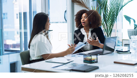 Business women, strategy and team planning in office, discussion or brainstorming insurance policy with paper. Laptop, meeting or conversation with manager for report, risk management or explain idea 126208255