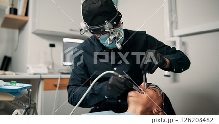 Appointment, medical procedure and woman with dentist in office for healthcare or mouth operation. Checkup, dental hygiene or oral exam with person and medicine professional at clinic for dentistry Appointment, medical procedure and woman with dentist in office for healthcare or mouth operation. Checkup, dental hygiene or oral exam with person and medicine professional at clinic for dentistry 126208482