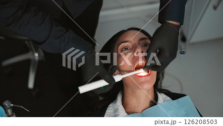 Hands, medical and mouth of patient with dentist in office for checkup, operation or surgery. Appointment, healthcare or oral exam with medicine professional and woman at clinic for dental hygiene 126208503