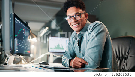 Man, trading and computer with portrait for charts, smile for review, typing or monitor for stocks at office. Person, happy and crypto investor at night by screen, value or market stats in Colombia 126208530