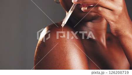 Skincare, serum and woman with product, hands and moisturizing of skin with liquid, hydration and studio. Gray background, dermatology and person with cosmetics for treatment, glow and smooth body 126208719