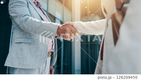 Business people, city and corporate deal with handshake for partnership, B2B or agreement. Closeup, employees or colleagues shaking hands with lens flare for greeting or introduction in an urban town Business people, city and corporate deal with handshake for partnership, B2B or agreement. Closeup, employees or colleagues shaking hands with lens flare for greeting or introduction in an urban town 126209450