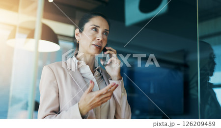 Phone call, business and woman in office by window for discussion, corporate meeting and planning. Professional, finance consultant and person on smartphone for contact, communication and talking 126209489