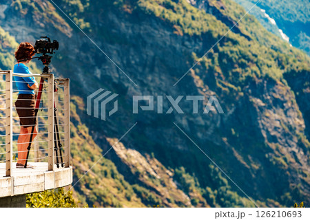 Tourist with camera on tripod in Norway nature 126210693