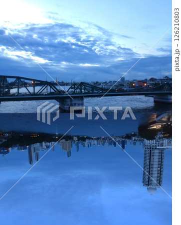up side down of Phra Phuttha Yodfa memorial bridge and building in other side in twilight sky on evening up side down of Phra Phuttha Yodfa memorial bridge and building in other side in twilight sky on evening 126210803