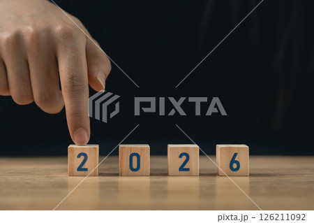 Hand arranging wooden blocks with numbers 2026 on a wooden surface symbolizing the approaching year and new beginnings for future planning and aspirations Hand arranging wooden blocks with numbers 2026 on a wooden surface symbolizing the approaching year and new beginnings for future planning and aspirations 126211092