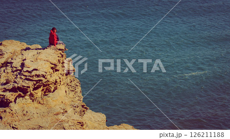Tourist woman on sea cliffs in Spain 126211188